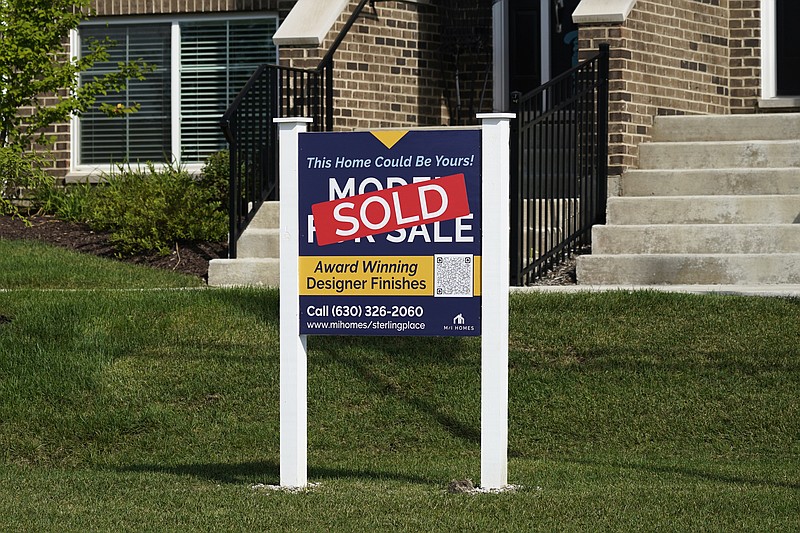 An advertising sign for building land stands in front of a new home construction site in Northbrook, Ill., Wednesday, Sept. 21, 2022.  Elevated home prices, rising interest rates and steep competition are interrupting millennials&#x2019; plans to get that quintessential piece of the American dream &#x2014; their first home, or an upgrade from a small starter home. If you were planning on buying a home over the past year or so, you may have started the process by getting a mortgage preapproval and working with a real estate agent, only to cancel it all and stay put.  (AP Photo/Nam Y. Huh)