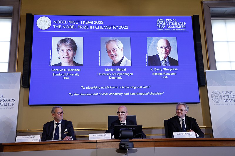 Secretary General of the Royal Swedish Academy of Sciences Hans Ellegren, centre, Jonas Aqvist, Chairman of the Nobel Committee for Chemistry, left, and Olof Ramstrom, member of the Nobel Committee for Chemistry announce the winners of the 2022 Nobel Prize in Chemistry during a press conference at the Royal Swedish Academy of Sciences on Wednesday, Oct. 5, 2022, in Stockholm, Sweden. The winners of the 2022 Nobel Prize in chemistry are Caroline R. Bertozzi of the United States, Morten Meldal of Denmark and K. Barry Sharpless of the United States. (Christine Olsson /TT News Agency via AP)