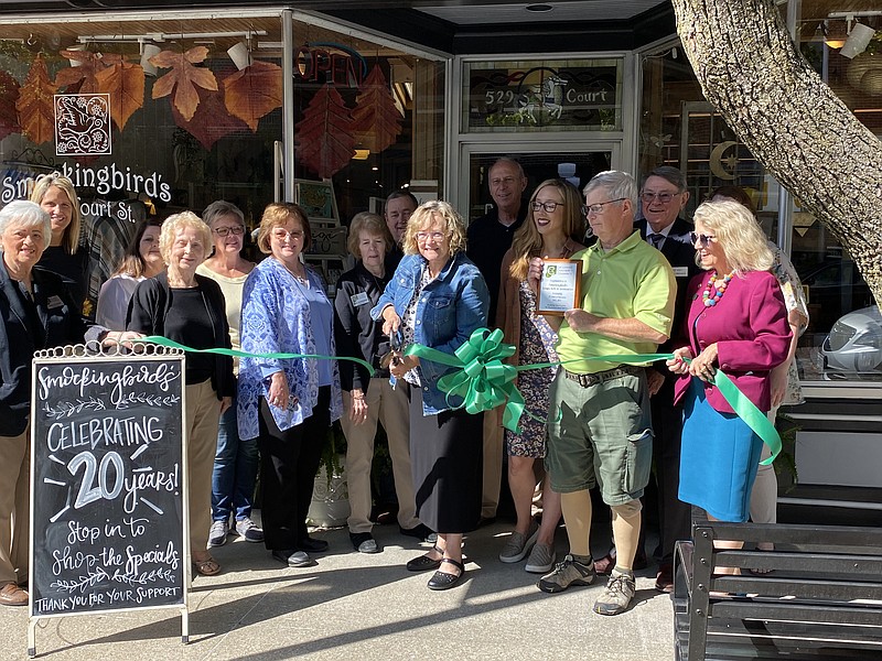 Virginia McCoskrie, owner of Smockingbird's Unique Gifts, cuts a ribbon to celebrate the 20th anniversary of the store. (Anakin Bush/Fulton Sun photo)