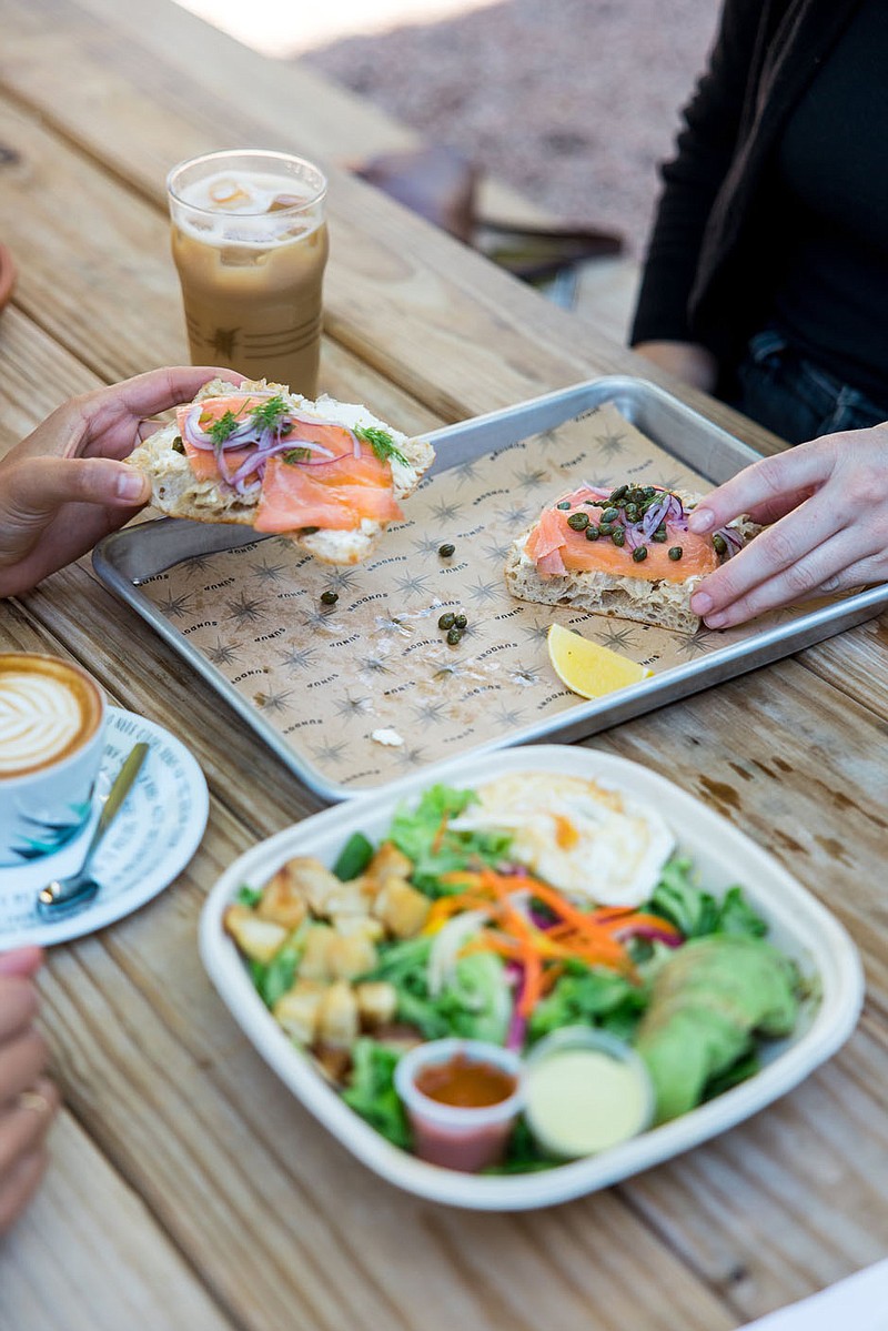 Patrons share food at the Meteor Cafe. Another edition of the cafe is scheduled to open next spring in Fayetteville’s South Yard development.

(Courtesy Photo/The Meteor Cafe)