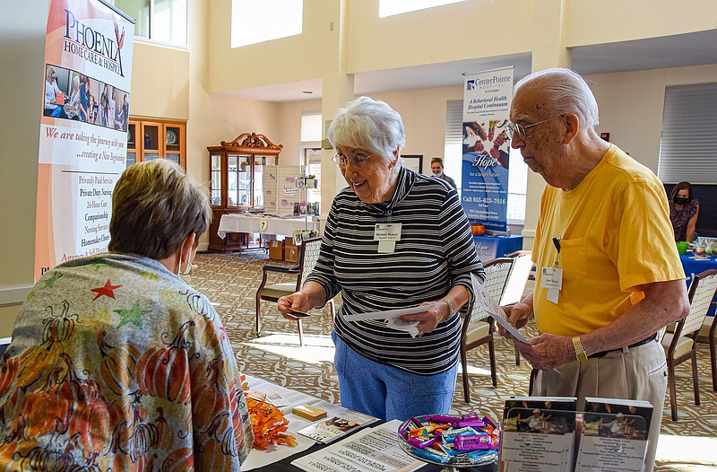 Julie Smith/News Tribune
Heisinger Bluffs hosted a "Health Like Never B4” health fair Thursday which featured several area vendors ranging from home health, financial and more. Joe and Barb Weaver, in back, are shown stopping to visit with Gwen Kirby of Phoenix Home Care and Hospice.