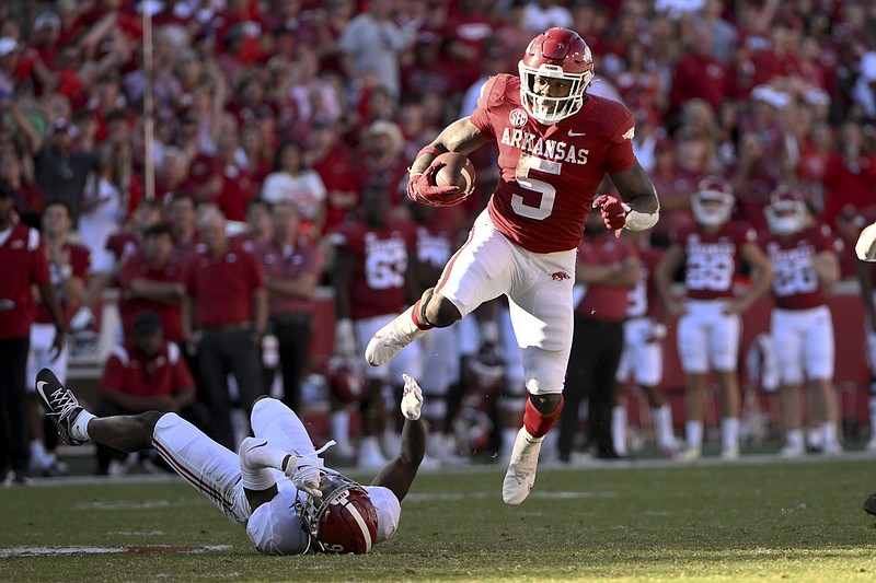 Arkansas running back Raheim Sanders (5) slips past Alabama defensive back Jordan Battle (9) Oct. 1 in Fayetteville. - Photo by Michael Woods of The Associated Press