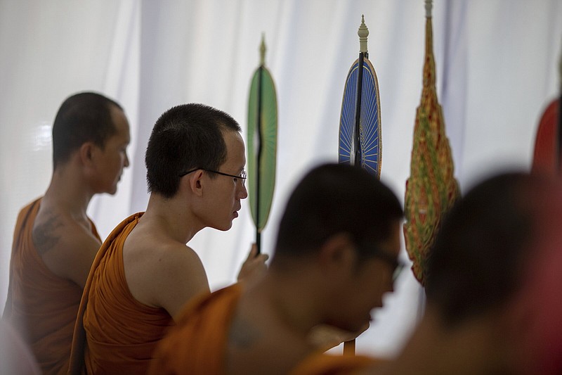 Monks pray over a funeral for the victims of the day care center attack inside Wat Rat Samakee temple in Uthai Sawan, north eastern Thailand, Saturday, Oct. 8, 2022. A former police officer burst into a day care center in northeastern Thailand on Thursday, killing dozens of preschoolers and teachers before shooting more people as he fled. (AP Photo/Wason Wanichakorn)