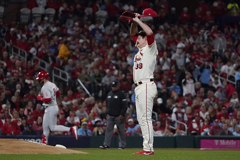 St. Louis Cardinals starting pitcher Miles Mikolas wipes his face after giving up a solo home run to Philadelphia Phillies' Bryce Harper during the second inning in Game 2 of an NL wild-card baseball playoff series Saturday, Oct. 8, 2022, in St. Louis. (AP Photo/Jeff Roberson)
