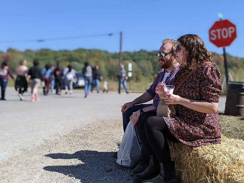 Ryan Pivoney/News Tribune photo: 
Erin Sumner and Brett Norton sat on a hay square Sunday, Oct. 9, 2022, to enjoy ice cream at the annual Hartsburg Pumpkin Festival. The couple have traveled from Columbia to attend the festival for the past three years.