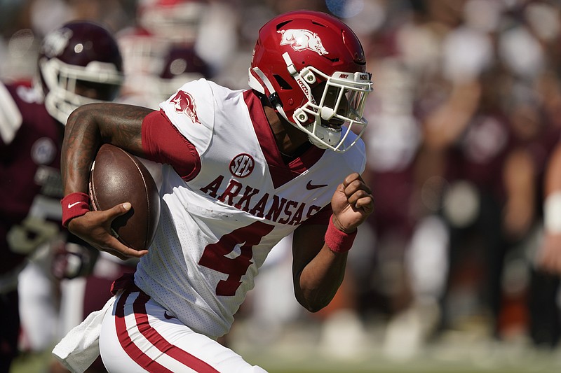 Arkansas quarterback Malik Hornsby (4) runs the ball for a first down against Mississippi State Saturday in Starkville, Miss. - Photo by Rogelio V. Solis of The Associated Press