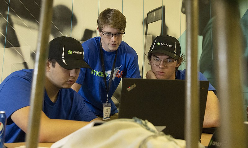 From left: Henry Vannoi, Harrison Cain and Isaac Hubberd of the Treble Makers team, work on their project during the Make48 engineering challenge competition at the Innovation Hub in North Little Rock on Sunday, Oct. 9, 2022. (Arkansas Democrat-Gazette/Colin Murphey)