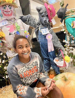 Submitted Photo
Avery Faith Jowers, a member of the Gravette Gleamers 4-H Club, poses with the wolf scarecrow she created for entry in the Benton County Fair. Avery won Reserve Grand Champion honors for her scarecrow. The scarecrow contest was a first time competition at this year's fair.