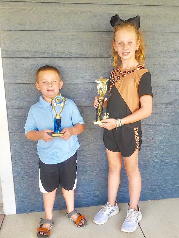 Submitted Photo
Jace Dillon and his sister Danielle display trophies they won in competition at the 2022 Benton County Fair. The siblings are active in various 4-H projects and show both beef heifers and goats in livestock shows. They were winners this year at both the county fair and the Arkansas Youth Expo the next weekend in Fayetteville.