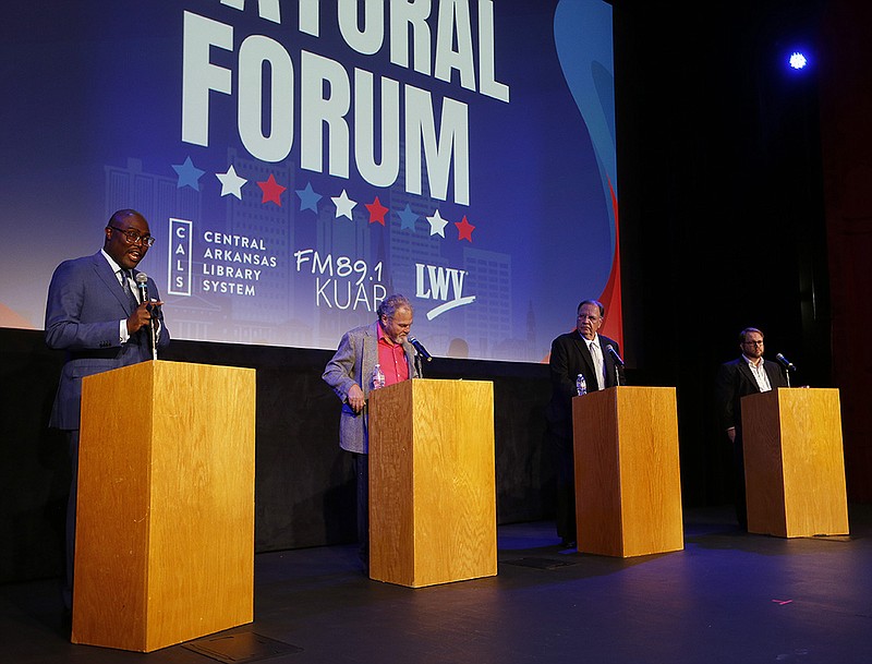 Incumbent Mayor Frank Scott Jr. (left) answers a question as fellow mayoral candidates, Glenn Schwarz (left center), Steve Landers Sr. (right center) and Greg Henderson (right) look on during the Little Rock Mayoral Forum on Monday, Oct. 10, 2022, at the CALS Ron Robinson Theater in Little Rock. 
(Arkansas Democrat-Gazette/Thomas Metthe)