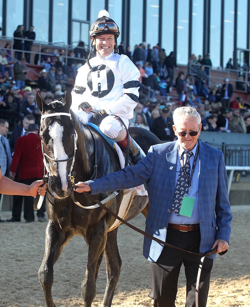 Owner Willis Horton, right, leads jockey Jon Court and Long Range Toddy (2) into the winner's circle after winning the tirst division of the Rebel Stakes at Oaklawn Park on March 16, 2019. - File photo by The Sentinel-Record