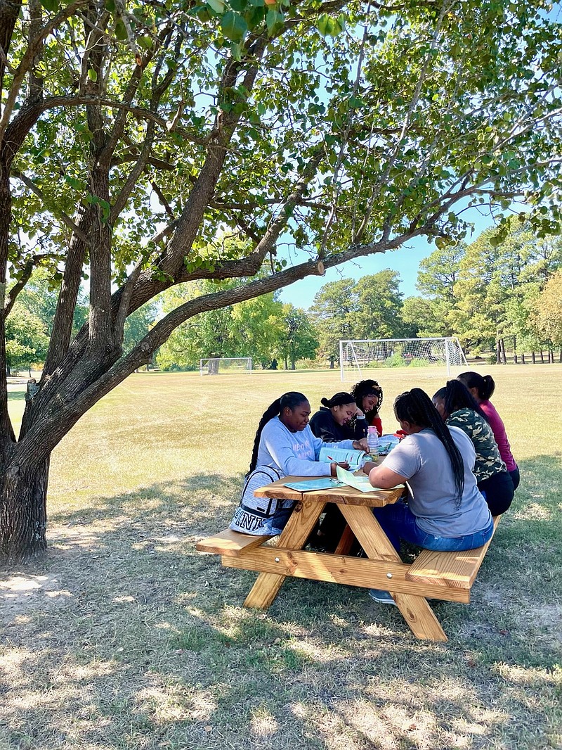 Texarkana College licensed vocational nursing students take a study break at a new picnic table built by the college’s construction technology students in Texarkana, Texas. (Photo courtesy of TC)