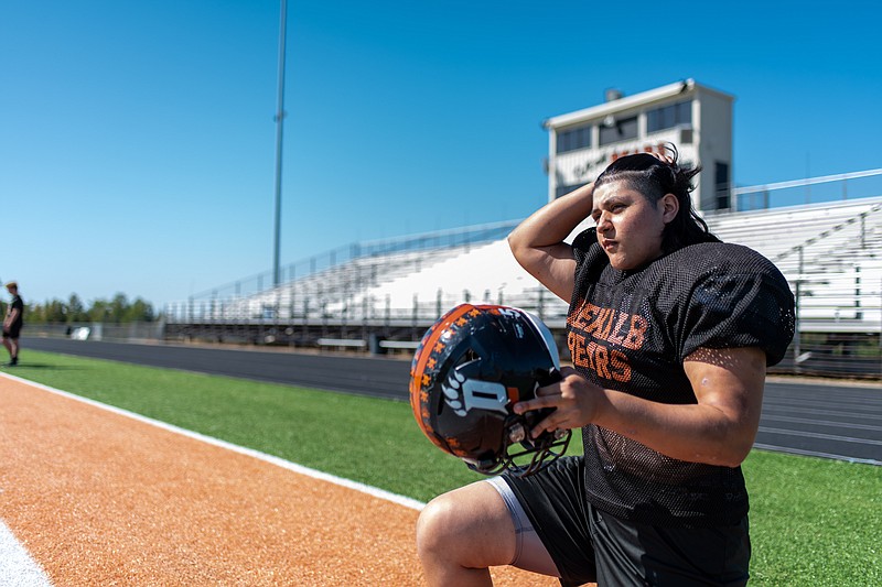 DeKalb High School senior Jessica Rivas prepares to put on her helmet during a team practice Thursday, Oct. 13, 2022, ahead of the Bears' game against Prairiland on Friday, Oct. 14. (Photo by Erin DeBlanc)