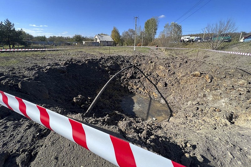 This handout photo released by Vyacheslav Gladkov, governor of the Belgorod region, claims to show a crater created by an explosion after alleged Ukrainian military shelling, outside Belgorod, Russia, Sunday, Oct. 16, 2022. Russian officials said their air defenses in the southern Belgorod region bordering Ukraine shot down "a minimum" of 16 Ukrainian missiles, Ria Novosti reported. (Vyacheslav Gladkov, governor of the Belgorod region in his telegram channel via AP)