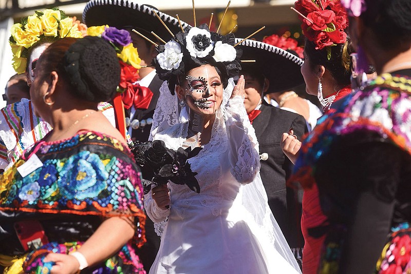 DIA DE LOS MUERTOS PROCESSION
Marchers take part Saturday Nov. 6 2021 in the Dia de los Muertos, or Day of the Dead, Cartinas Processional through downtown Springdale during the Dia de los Muertos celebration. Day of the Dead is a religious holiday in many Latin American countries that is also observed in the United States, including festivities at Shiloh Square in Springdale. Dia de los Muertos is a time to remember and honor loved ones who have died. Activities on Saturday included the Catrinas Processional, a bicycle ride hosted by Arkansas Latinas En Bici and performances by dance troupes and mariachi bands. Dia de los Muertos is usually celebrated the first part of November to coincide with the Catholic holy days of All Saints Day' and All Souls' Day. Shiloh Museum of Ozark History in downtown Springdale features a Dia de los Muertos exhibit through Dec. 4. Go to nwaonline.com/211107Daily/ to see more photos.
(NWA Democrat-Gazette/Flip Putthoff)