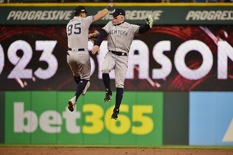 New York Yankees' Oswaldo Cabrera, left, and Harrison Bader celebrate after the Yankees defeated the Cleveland Guardians in Game 4 of a baseball AL Division Series, Sunday, Oct. 16, 2022, in Cleveland. (AP Photo/Phil Long)