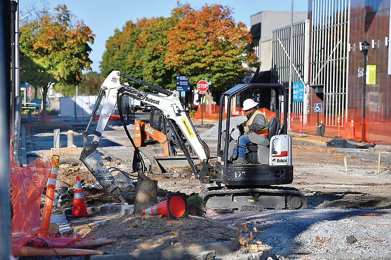 Workers with Milestone Construction operate a mini excavator Monday, Oct. 17, 2022, as work continues on Emma Avenue in Springdale. Emma Avenue is closed to vehicular traffic east of Holcomb Street to allow for a realignment of the Razorback Greenway and other improvements. The closure is expected to last until the $4.5 million project is complete in spring 2023. Visit nwaonline.com/221018Daily/ for today's photo gallery. 
(NWA Democrat-Gazette/Andy Shupe)