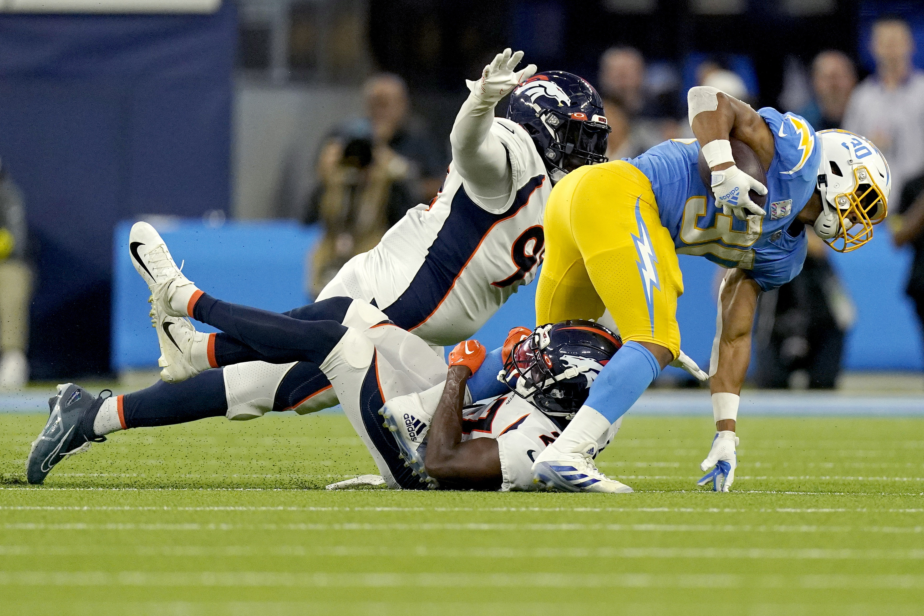 Denver, Colorado, USA. 8th Jan, 2023. Chargers WR MIKE WILLIAMS tries to  shake off a tackle by Broncos S JUSTIN SIMMONS during the 2nd. Half at  Empower Field at Mile High Sunday