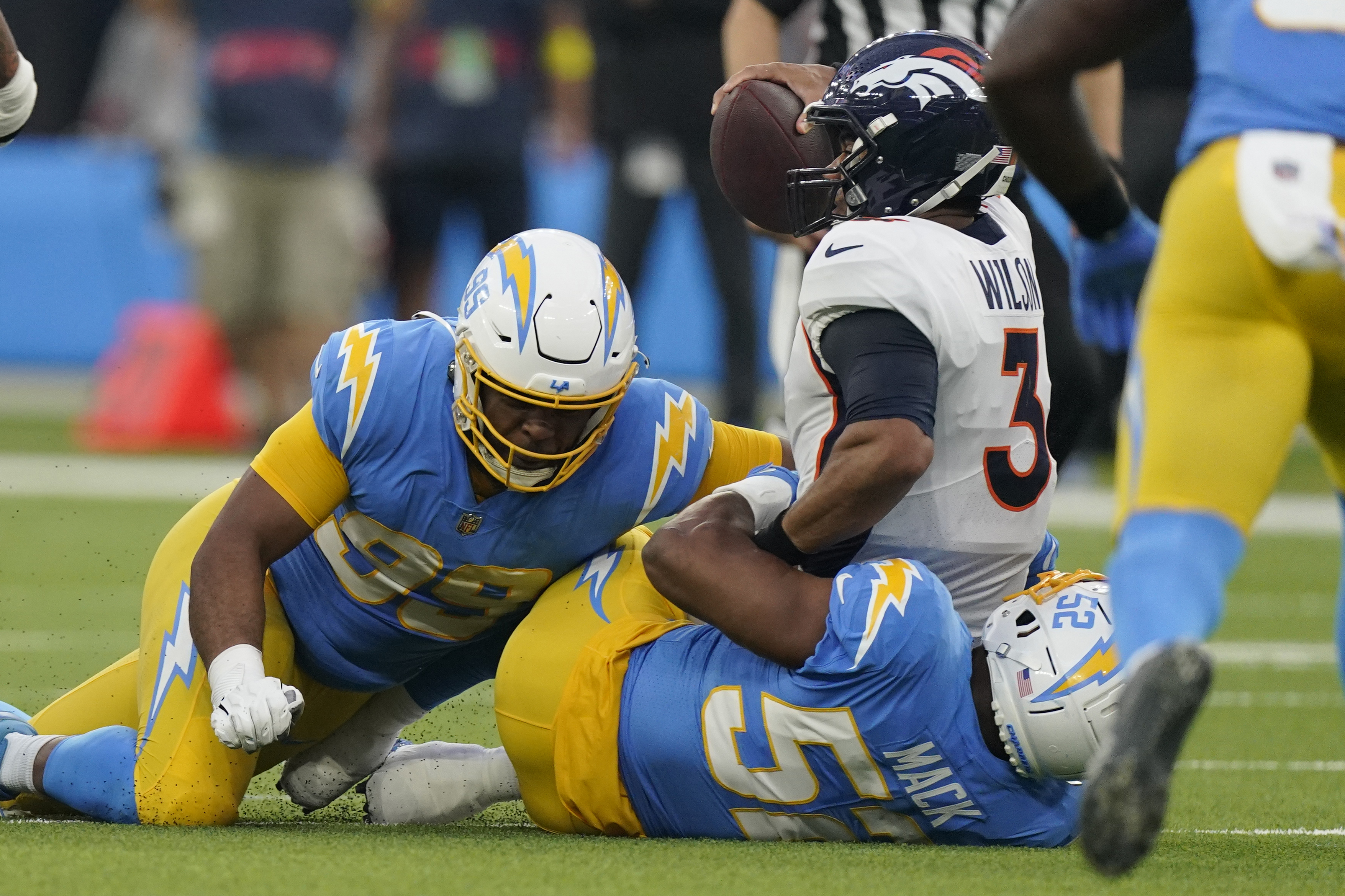 Denver, Colorado, USA. 8th Jan, 2023. Chargers WR MIKE WILLIAMS tries to  shake off a tackle by Broncos S JUSTIN SIMMONS during the 2nd. Half at  Empower Field at Mile High Sunday