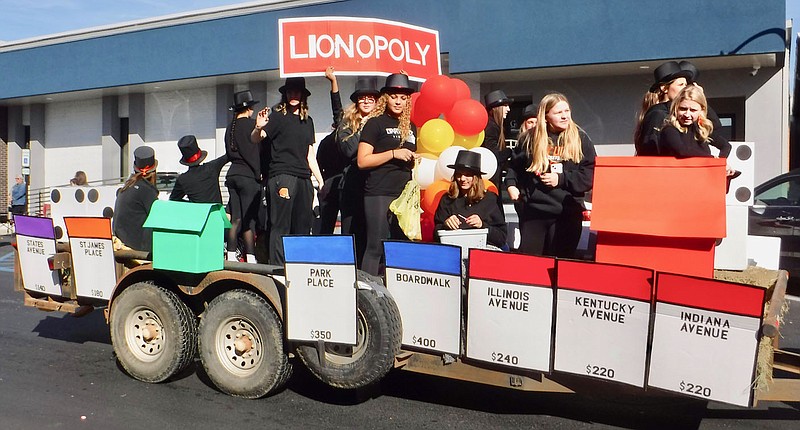 Westside Eagle Observer/SUSAN HOLLAND
Members of the high school girls basketball team ride on their Lionopoly float in the 2022 homecoming parade. The team, with their clever twist on the classic Monopoly game, won the prize for best float entered by sports teams or school clubs.