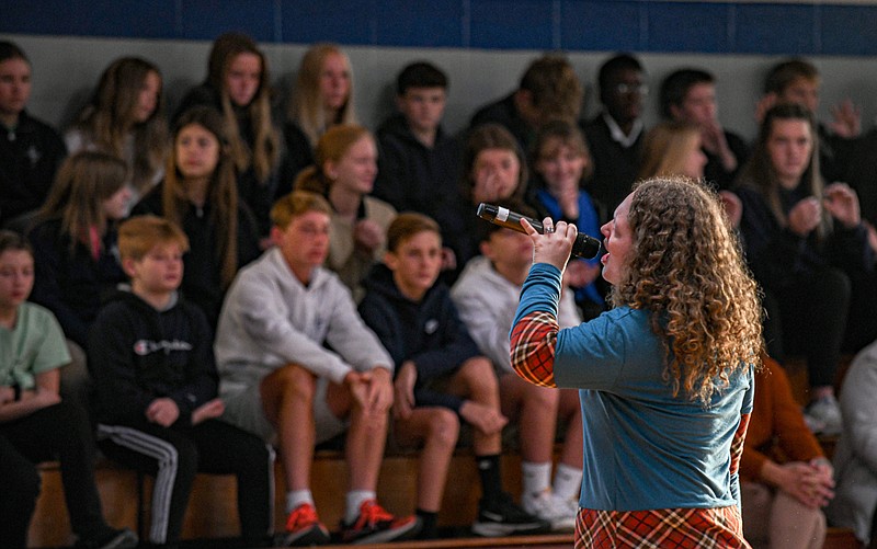 Julie Smith/News Tribune photo: 
Jess Angelique of Next Gen Assemblies sings for students at Immaculate Conception School Wednesday, Oct. 19, 2022, during a morning assembly where she and partner Mike Dawson talked about their respective life struggles and how they overcame them. The assembly is designed to impart to students that "they matter, they have value and they have purpose," thereby making them MVP's.