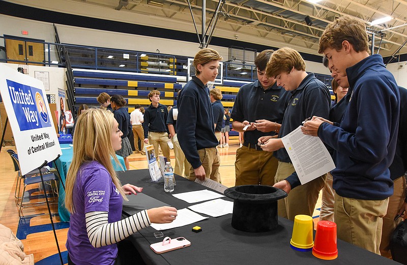 Julie Smith/News Tribune photo: 
Hannah Gerard, left, of the United Way of Central Missouri talks to Helias Catholic High School students Wednesday, Oct. 19, 2022, during the school's service fair. Gerard explained how the agency and its partner agencies serve communities. The students are, from right to left: Harper Moats, Gavin Hoelscher, Jude Dallmeyer, Nick Petty and Nate Strope.