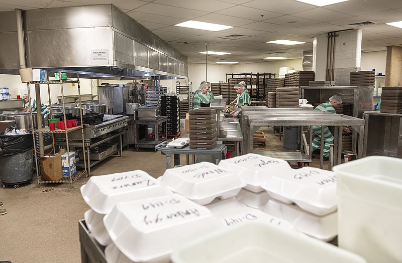 Inmates at the Benton County Jail work in the jails kitchen Friday, Oct. 14, 2022 in Bentonville. Voters will decide on Nov. 8 whether to expand the Benton County Jail due to overcrowding.
(NWA Democrat-Gazette/Spencer Tirey)