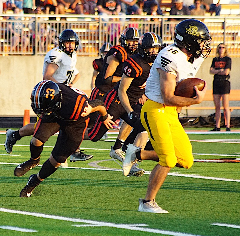 Prairie Grove senior Ethan Miller takes off for a big gain against Gravette in a game played earlier this season. The Tigers are seeking a playoff berth in their first season in the 5A-West Conference with Miller leading the way. 
Westside Eagle Observer/RANDY MOLL