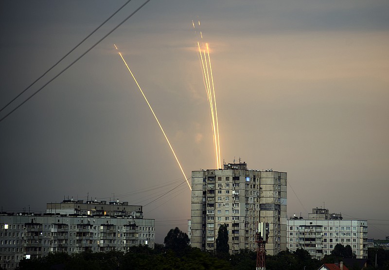 FILE - Russian rockets are launched against Ukraine from Russia's Belgorod region at dawn in Kharkiv, Ukraine, Aug. 15, 2022. Eight months after Russian President Vladimir Putin launched an invasion against Ukraine expecting a lightening victory, the war continues, affecting not just Ukraine but also exacerbating death and tension in Russia among its own citizens. (AP Photo/Vadim Belikov, File)