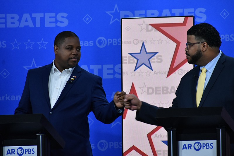 Democratic nominee Chris Jones, left, and Libertarian nominee Ricky Dale Harrington, right, fist-bump before a gubernatorial debate Friday at the University of Central Arkansas' Reynolds Performance Hall in Conway. (Pine Bluff Commercial/I.C. Murrell)