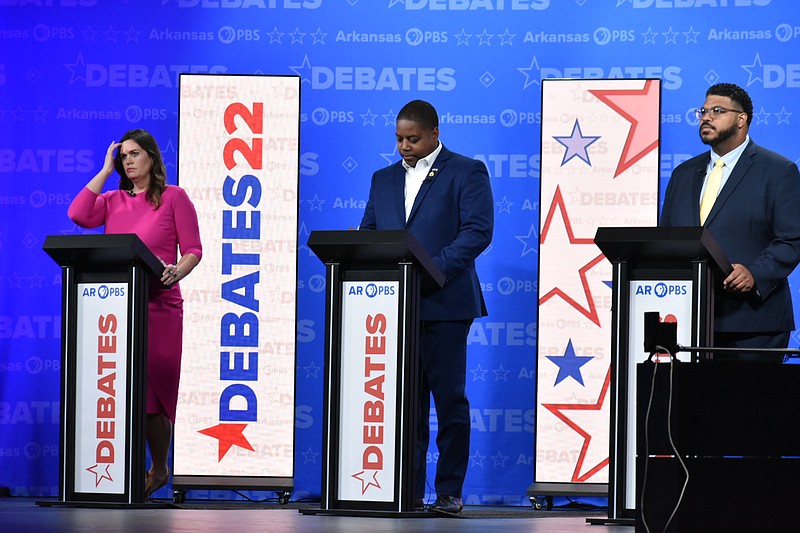 From left, Republican nominee Sarah Huckabee Sanders, Democratic nominee Chris Jones and Libertarian nominee Ricky Dale Harrington stand behind their podiums before the gubernatorial debate Friday, Oct. 21, 2022, at the University of Central Arkansas' Reynolds Performance Hall in Conway. (Pine Bluff Commercial/I.C. Murrell)