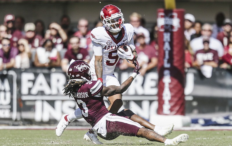 Arkansas wide receiver Jadon Haselwood (9) carries the ball as Mississippi State cornerback Decamerion Richardson (3) blocks Oct. 8 during the third quarter at Davis Wade Stadium in Starkville. - Photo by Charlie Kaijo of NWA Democrat-Gazette