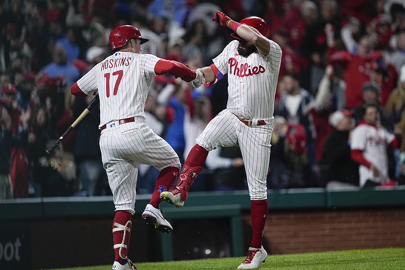 Rhys Hoskins of the Philadelphia Phillies celebrates by spiking