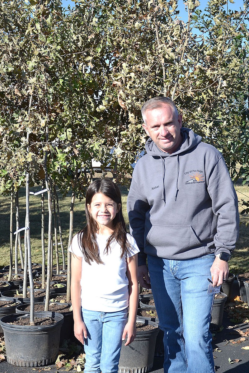 TIMES photograph by Annette Beard
Aria Butler, Little Miss Pea Ridge, recently won the Miss Arkansas title for the National American Miss program. She stopped by the tree give-away recently and talked with Nathan See, Street Department superintendent.