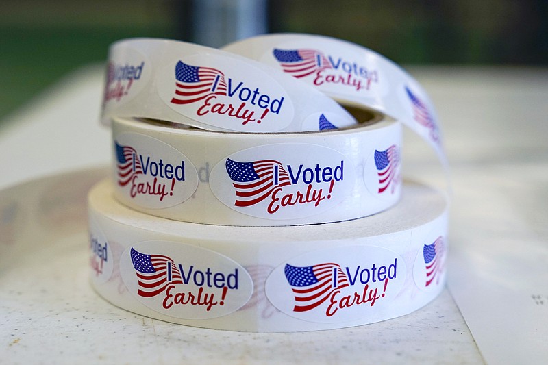 FILE - Rolls of "I Voted Early" stickers await voters in the final hours of early voting in the primary election in Noblesville, Ind., May 2, 2022. Election Day is still 12 days away. But in courtrooms across the country, efforts to sow doubt over the outcome have already begun. (AP Photo/Michael Conroy, File)