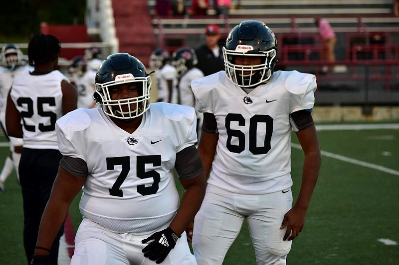 White Hall linemen Jaylon James (75) and Enrique Velazquez (60) warm up before an Oct. 14 game at Pine Bluff. (Pine Bluff Commercial/I.C. Murrell)