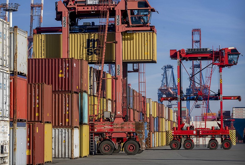 Containers are photographed in the harbor in Hamburg, Germany, Wednesday, Oct. 26, 2022. The German government agreed on a compromise to allow Chinese shipping group COSCO to take a smaller stake than previously planned in the operator of the country’s biggest container terminal, over concerns that they pose a national security risk.  (AP Photo/Michael Probst)