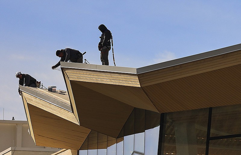 Workers on the roof at the Arkansas Museum of Fine Arts continue the renovation work on the museum Friday Oct. 28, 2022  in Little Rock. The grand opening for the museum is set for  April 22, 2023.  (Arkansas Democrat-Gazette/Staton Breidenthal).