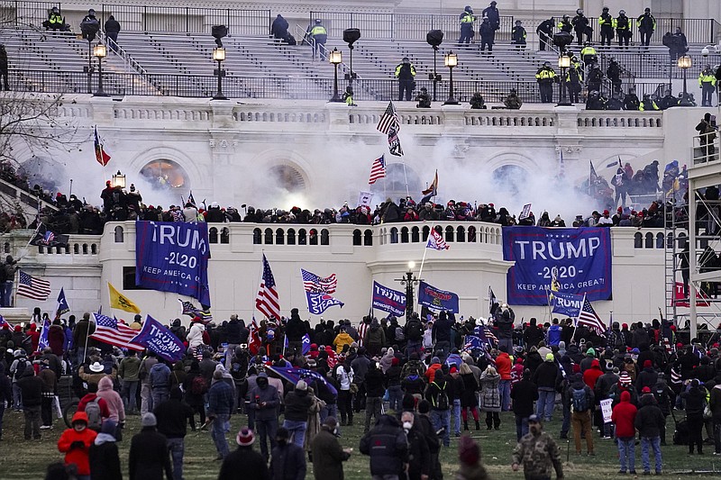 FILE - Violent rioters, loyal to President Donald Trump, storm the Capitol in Washington,  Jan. 6, 2021. A former U.S. Capitol Police officer was convicted of obstruction of justice on Friday, Oct. 28, 2022, for deleting Facebook messages he exchanged with a man who participated in the Jan. 6, 2021 insurrection. Jurors were unable to reach a verdict on a second count of obstruction against Michael A. Riley, 51, that stemmed from Riley warning the rioter to remove part of a Facebook post showing the person inside the Capitol during the riot. (AP Photo/John Minchillo, File)