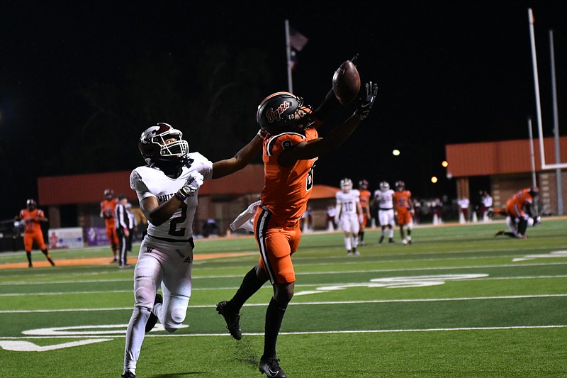 Photo by Kevin Sutton
Texas High's Xavier Dangerfield (8) leaps to make a reception in front of Whitehouse's Dominic Rayford (2) during Friday's game. Whitehouse defeated the Tigers, 32-27.