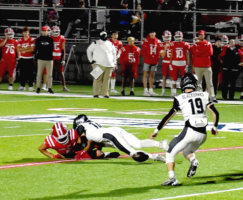 MARK HUMPHREY  ENTERPRISE-LEADER/Pea Ridge senior Jonathan Lyons, a 5-feet-10, 140-pound cornerback, tackles Farmington's Cooper Gardenhire while teammate Austin James eyes a fumble. The Blackhawks foiled a 2-point conversion attempt on this play during 5A West football action at Farmington's Cardinal Stadium on Friday, Oct. 28, 2022. Farmington won 49-16.