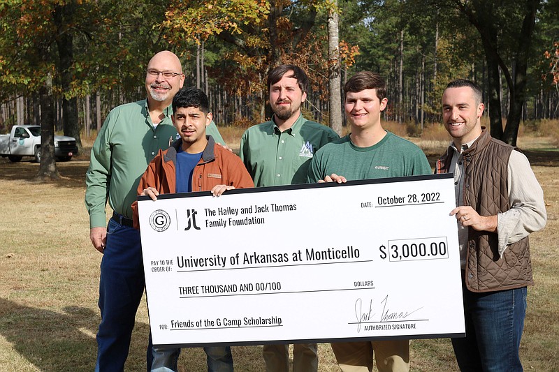 Matthew Pelkki (left) Jovanny Martinez, Patrick Phillips, Timothy Chapman, and Jack Thomas display a check. (Special to The Commercial/University of Arkansas at Monticello)