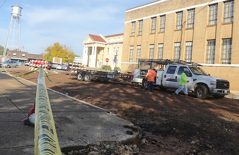 Looking from the front of the post office toward the former county office building, the sidewalk and street is under construction leading to the Cass County Courthouse. At the edge, Kaufman Street crosses the square. (Photo by Neil Abeles)