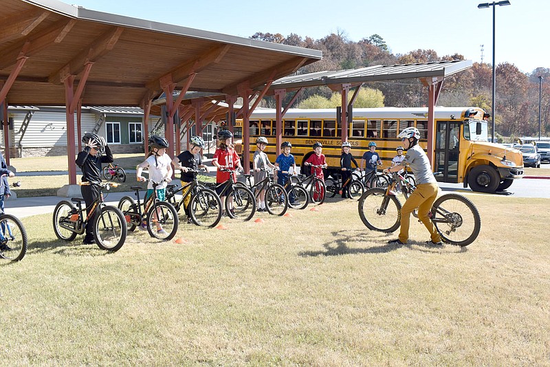 Rachel Dickerson/The Weekly Vista Anya Bruhin (right) of Trailblazers walks Cooper Elementary School students through an exercise on Oct. 31. Trailblazers was at the school doing a photo shoot for a new grant program for the whole state.