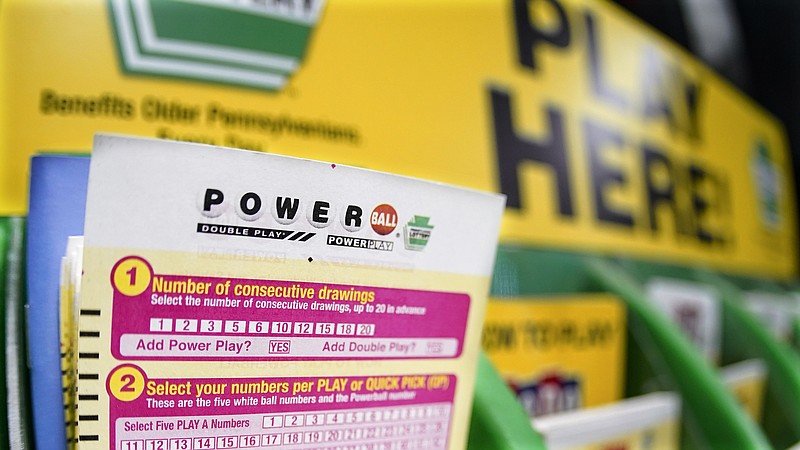 FILE - A rack with cards bettors can use to choose their own numbers to purchase lottery tickets for the Saturday Oct. 29, drawing of the Powerball lottery, are seen on a counter at a market in Prospect, Pa., Friday, Oct. 28, 2022.  The fourth-largest lottery jackpot in U.S. history could soar to the largest ever if no one wins the top prize in Wednesday, Nov. 2, Powerball drawing. (AP Photo/Keith Srakocic)