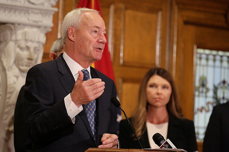 Gov. Asa Hutchinson announces the expansion of the ARHOME Medicaid Program as Rep. Michelle Gray (right), R-Melbourne, looks on during a press conference on Tuesday, Nov. 1, 2022, at the state Capitol in Little Rock. 
(Arkansas Democrat-Gazette/Thomas Metthe)