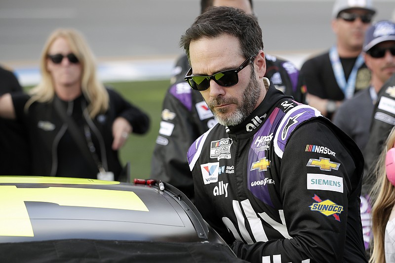 FILE - Jimmie Johnson climbs into his car before the NASCAR Daytona 500 auto race at Daytona International Speedway in Daytona Beach, Fla., Feb. 16, 2020. Seven-time NASCAR champion Jimmie Johnson is returning to NASCAR two years after his retirement from the stock car series. Johnson bought a stake in GMS Petty Racing, a Cup team fronted by seven-time champion Richard Petty. Johnson will also run up to five races in 2023 beginning with the season-opening Daytona 500. (AP Photo/John Raoux, File)