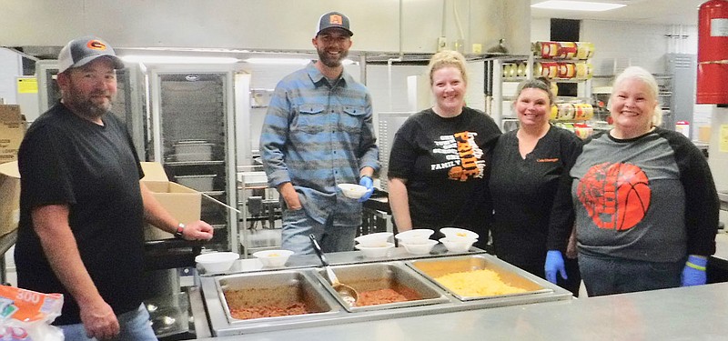 Westside Eagle Observer/SUSAN HOLLAND
Kitchen helpers at the Glenn Duffy Elementary fall festival pause from serving chili to pose for the camera. School board members Matt Croxdale, Brad Harris and Robyn Lovell (far right) served several bowls of chili during the evening. Also pictured are Arissa Blakeslee, manager of the high school cafeteria, and Tonia McEvans, manager of the Glenn Duffy cafeteria, who prepared the chili.