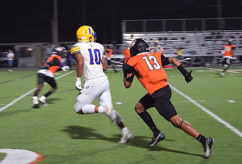 Malvern’s Donta Cage (13) trails Lakeside’s Kyler Wolf (10) Sept. 9 at Claude Mann Stadium. Malvern took on Arkadelphia in a battle for the Class 4A-7 title Nov. 5 and fell to the Badgers. - Photo by Donald Cross of The Sentinel-Record