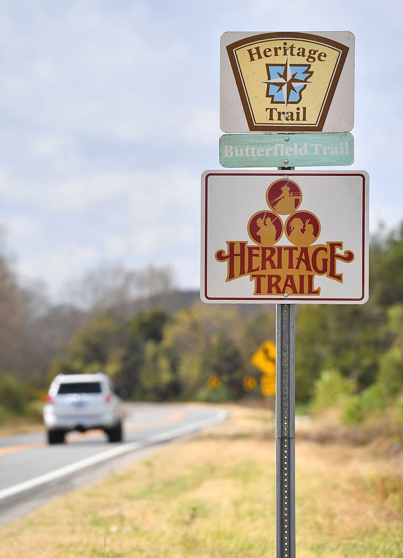 Traffic passes Friday by a sign promoting Arkansas 265 as a Heritage Trail that follows the original Butterfield Trail stagecoach route in Fayetteville. Visit nwaonline.com/221106Daily/ for today’s photo gallery.
(NWA Democrat-Gazette/Andy Shupe)